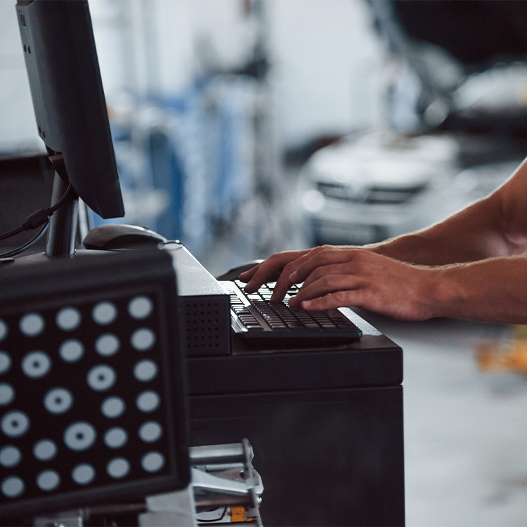 A closeup of a person working on a computer in a workshop