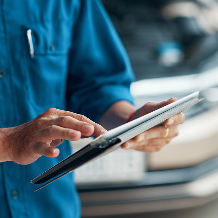 A closeup of a person working on an ipad 