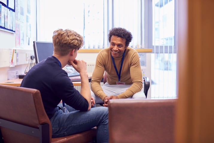 Two men sitting in an office discussing mental health