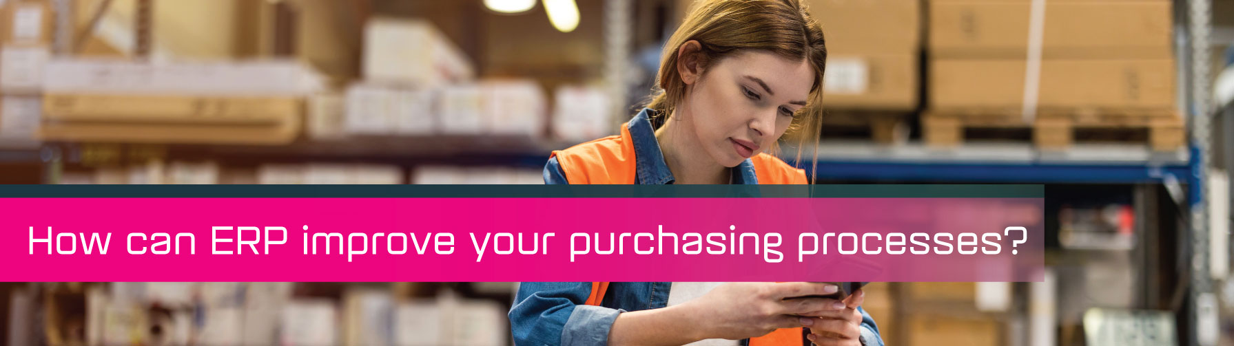 A woman in a warehouse using a digital device.