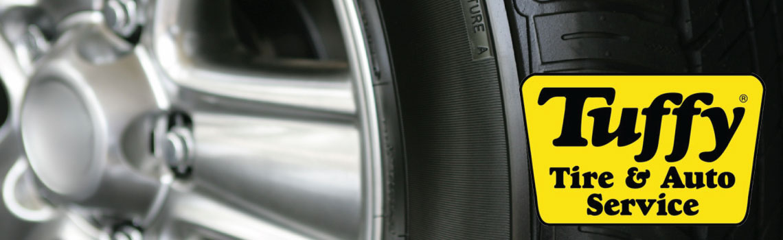A car rim and tire with the Tuffy Tire & Auto Service logo on