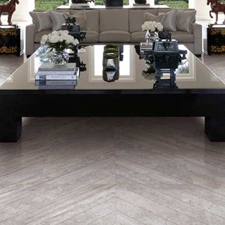 A coffee table with décor standing on herringbone tiles.