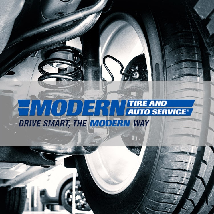 Modern Tire and auto service logo with a tire in the background.
