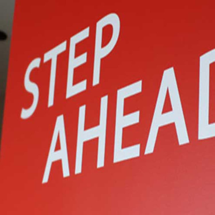 Ared sign that reads Step Ahead.