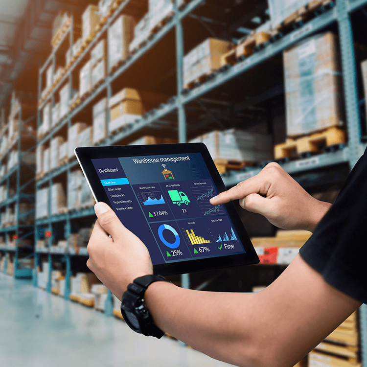 A man in an Irish warehouse with tablet showing logistics management dashboard.