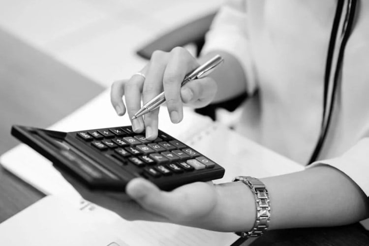 A woman using a calculator