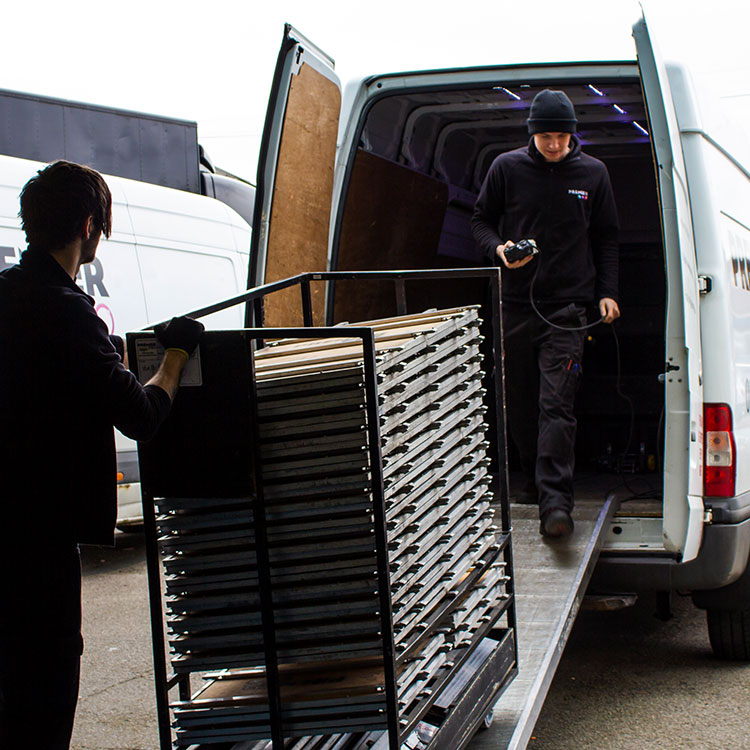 A man loading a van, preparing for transportation.