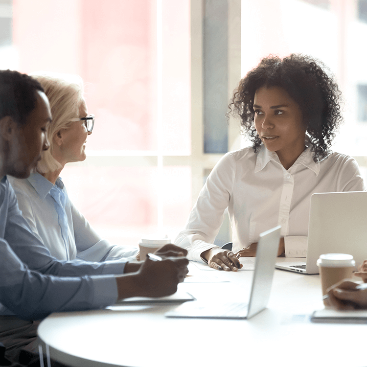 Employees sitting in a meeting having productive conversations.