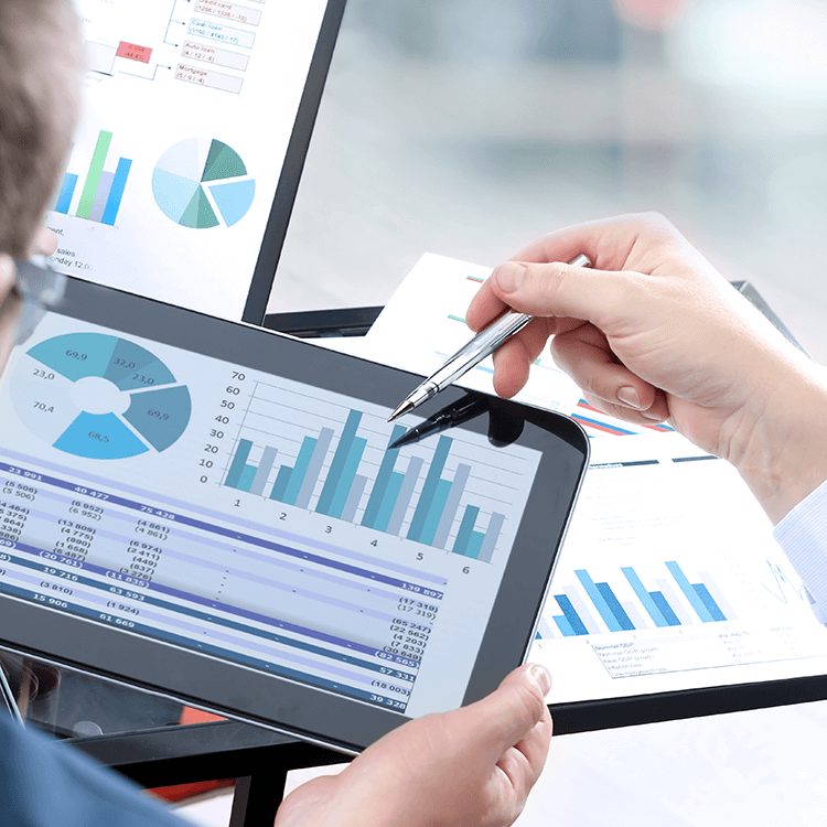 A man using KCS's ERP on a tablet to analyse business' bottom line and accounting.