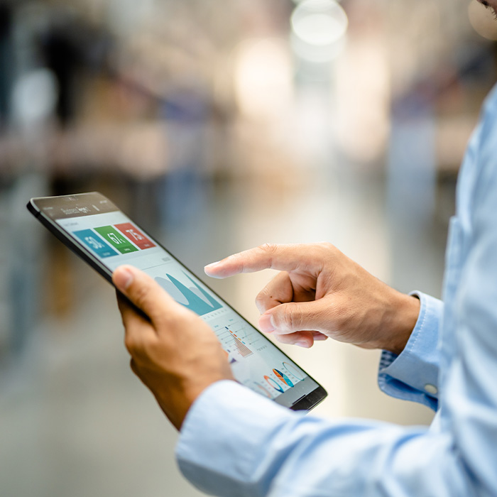 A man in a warehouse using a tablet to manage inventory and track shipments efficiently.