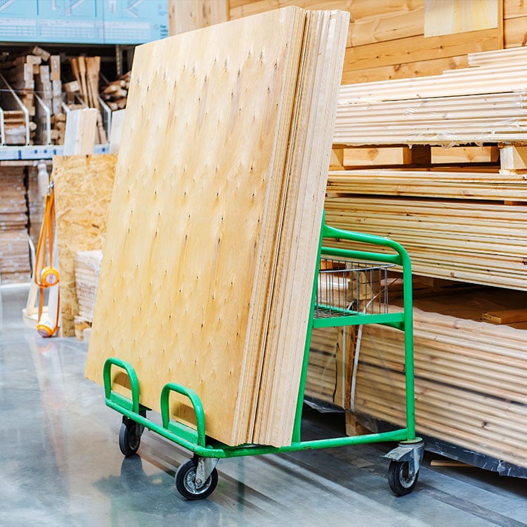 A cart loaded with a stack of lumber, ready for transportation.