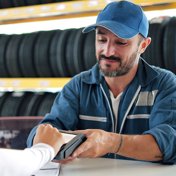 A man and a woman making a payment at an Irish tyre shop