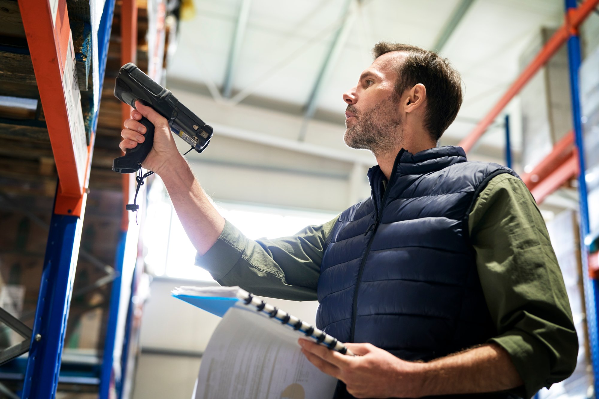caucasian-man-using-bar-code-reader-in-a-warehouse-2023-11-27-05-09-36-utc
