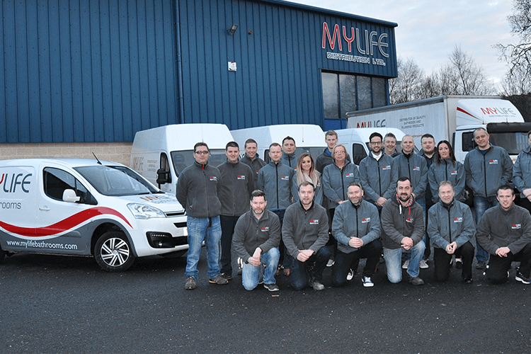 MyLife Bathrooms group employee photo infront of the store