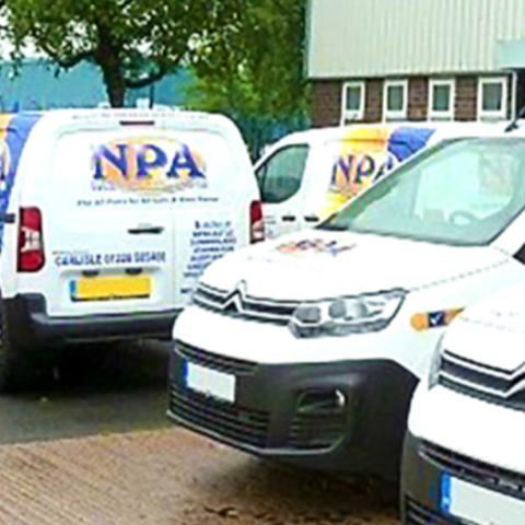 A parking lot filled with vans that have NPA Motor Factors branding