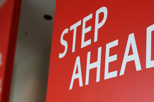 A red step ahead sign
