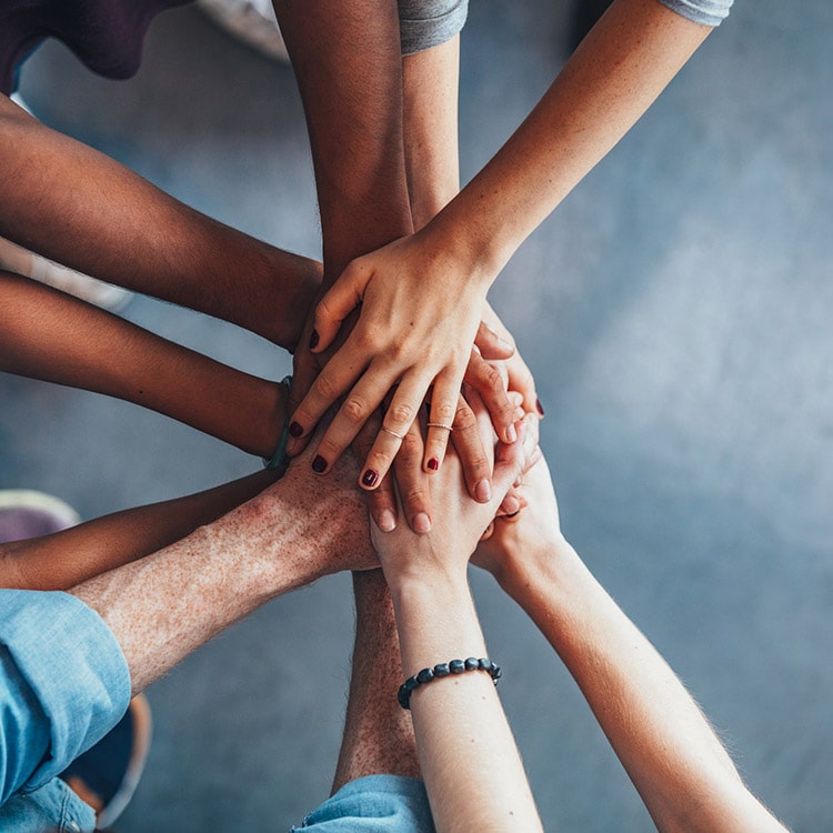 A group of people with their hands together